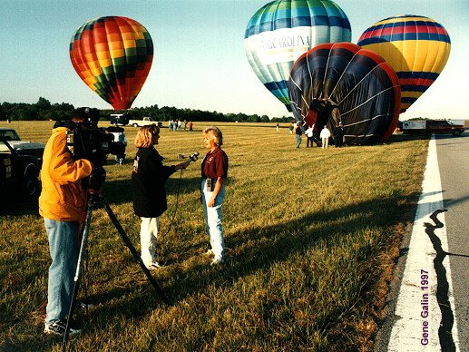 Carolyn being interviewed with me near lift-off in the background.